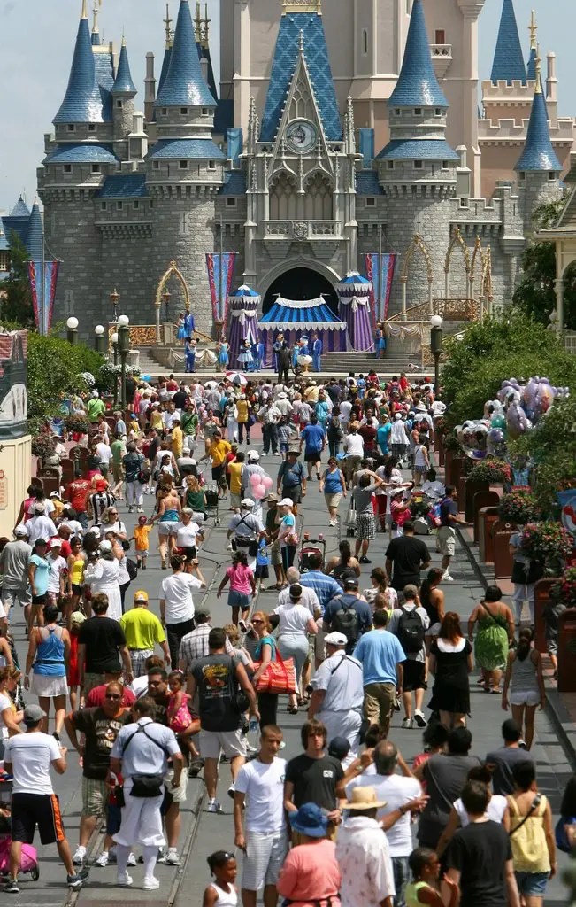 Crowds line the way to Cinderella Castle at the Magic Kingdom.Credit...Joe Burbank/Orlando Sentinel, via Associated Press